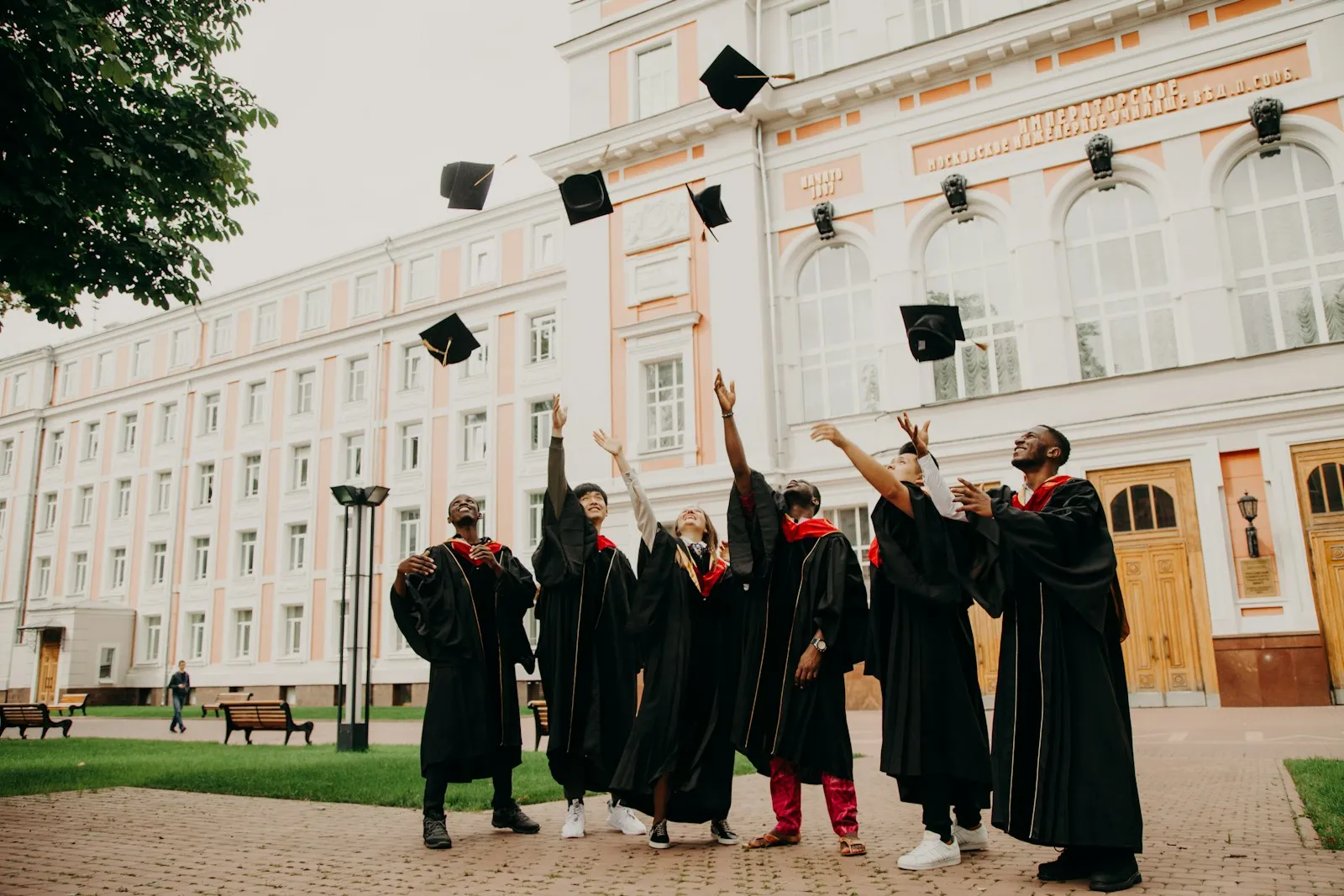 Graduate celebrating course completion with immigration support